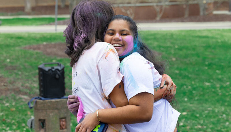 UM-Flint Holi celebration. During this celebration, students cover each other in colored paints as part of a traditional spring celebration.