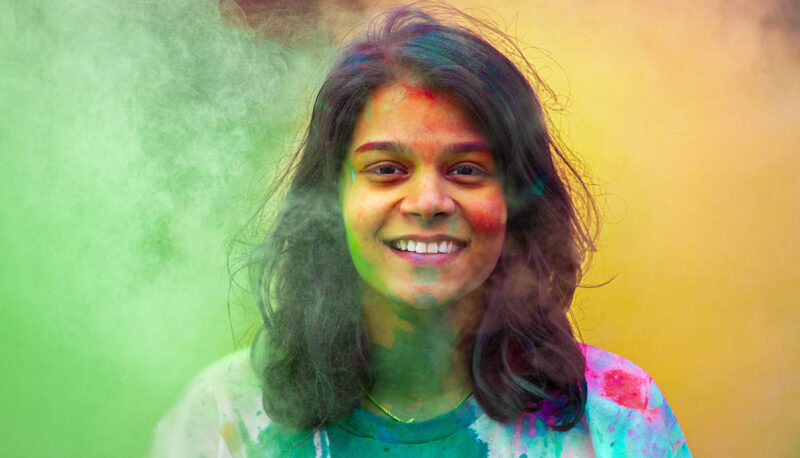 UM-Flint Holi celebration. During this celebration, students cover each other in colored paints as part of a traditional spring celebration.