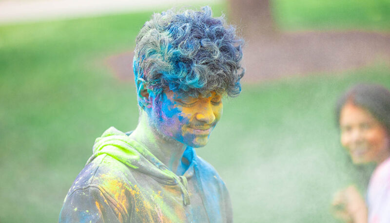 UM-Flint Holi celebration. During this celebration, students cover each other in colored paints as part of a traditional spring celebration.