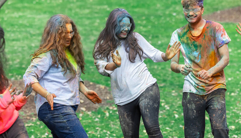 UM-Flint Holi celebration. During this celebration, students cover each other in colored paints as part of a traditional spring celebration.