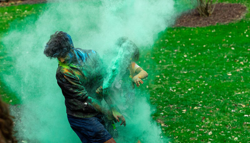 UM-Flint Holi celebration. During this celebration, students cover each other in colored paints as part of a traditional spring celebration.