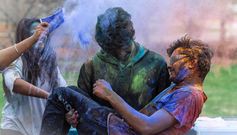 UM-Flint Holi celebration. During this celebration, students cover each other in colored paints as part of a traditional spring celebration.