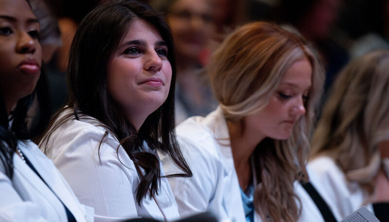 Students looking on in the crowd.