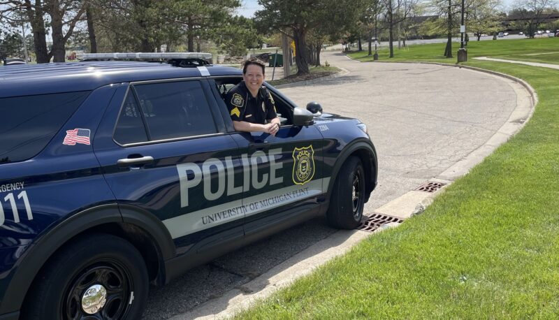 Sgt. Bromley smiling while leaning out from a patrol vehicle