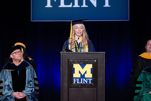 Taylor Culinski speaking at the podium