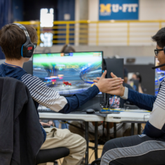 Two students high fiving during an Esports competition