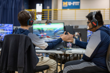 Two students high fiving during an Esports competition