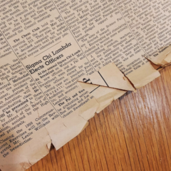 A tattered newspaper on a desk