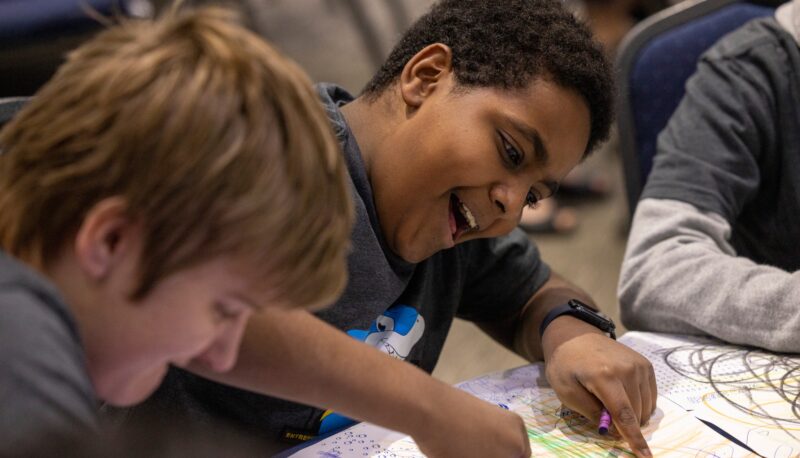 Young kids drawing with crayons