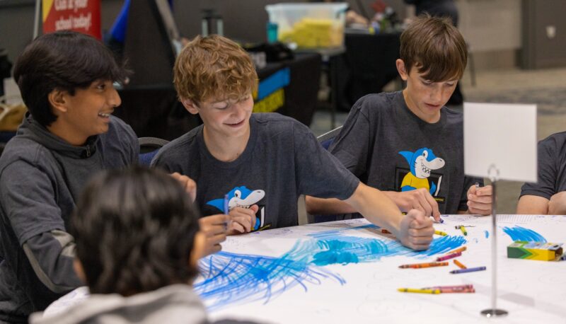 Kids using crayons at a table