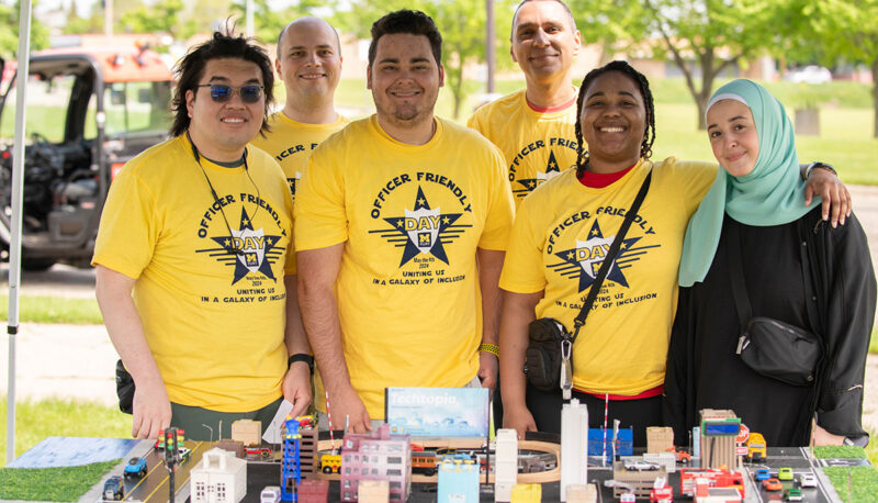 UM-Flint students posing with the model city