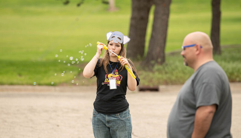 An Officer Friendly Day attendee blowing bubbles