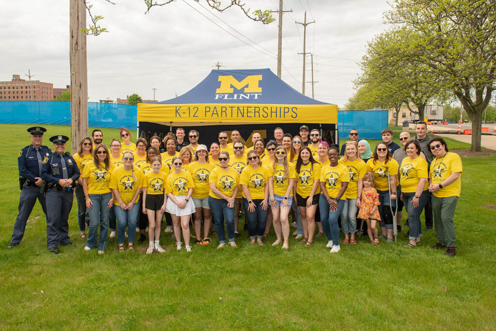 A group photo of Officer Friendly Day volunteers and police officers