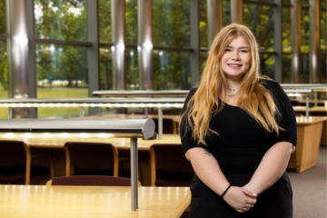 Elizabeth Ashley posing for a photo in the UM-Flint library