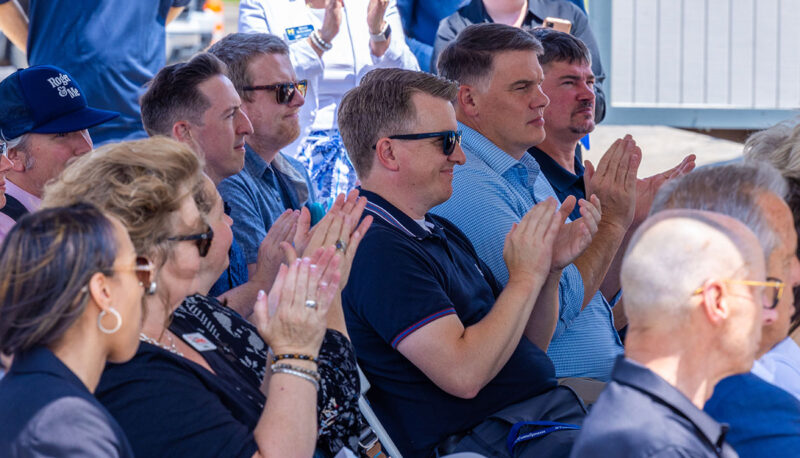 A seated crowd clapping.