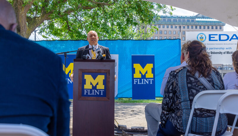 Flint Mayor Sheldon Neeley speaking at the podium.