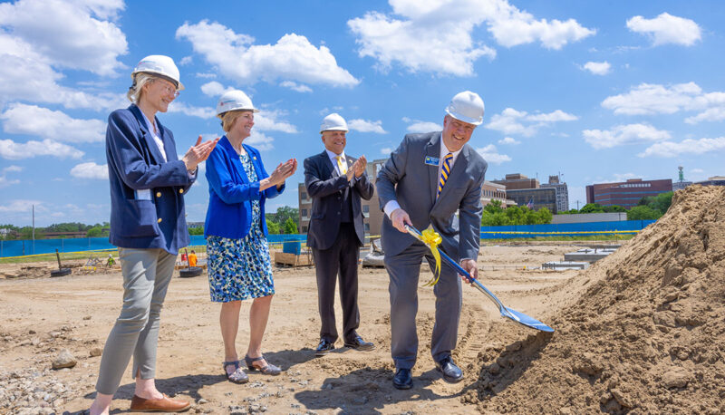 Christopher Pearson ceremonially groundbreaking with the shovel while Mott Foundation Program Director Kimberly Roberson, Donna Fry and Sheldon Neeley look on.