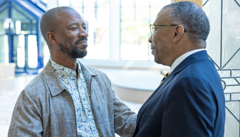 Chancellor Alexander shaking hands with a staff member.