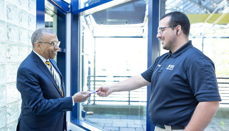 Chancellor Alexander shaking hands with a staff member.