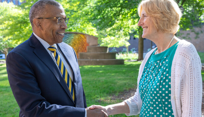 Chanellor Alexander shaking hands with Donna Fry