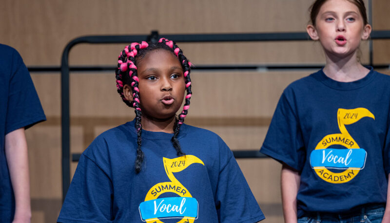 Campers performing on stage.