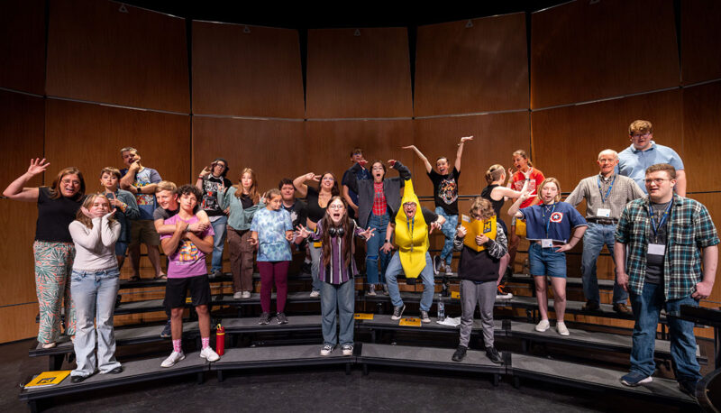 Campers posing for a photo on stage.