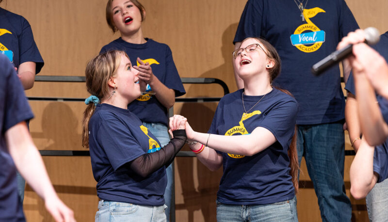 Campers singing on stage.