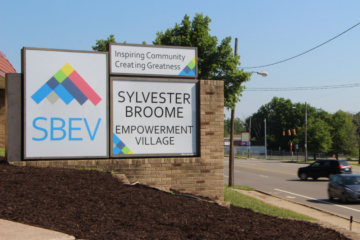 The Sylvester Broome Empowerment Village sign in front of their location in Flint