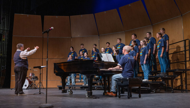 Singers performing on stage.