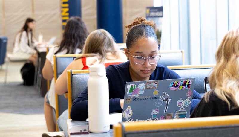 Students seated in booths on the 3rd floor of UCEN.