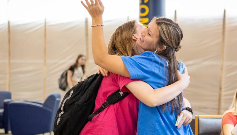 Two students hugging in UCEN.