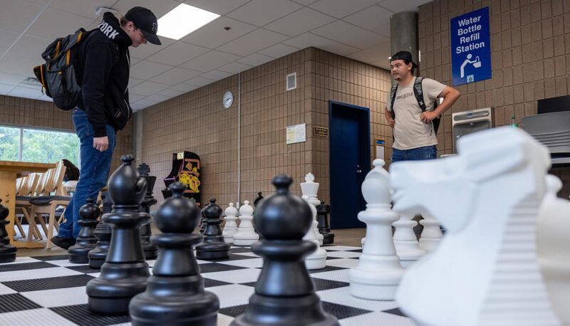 Students playing giant chess in UCEN.