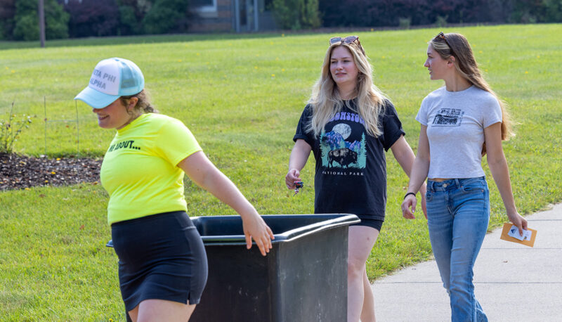 A bin filled with dorm items being pushed into First Street Residence Hall.