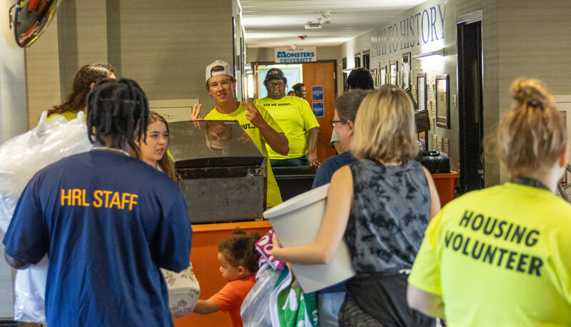 The lobby of First Street filled with people and bins.