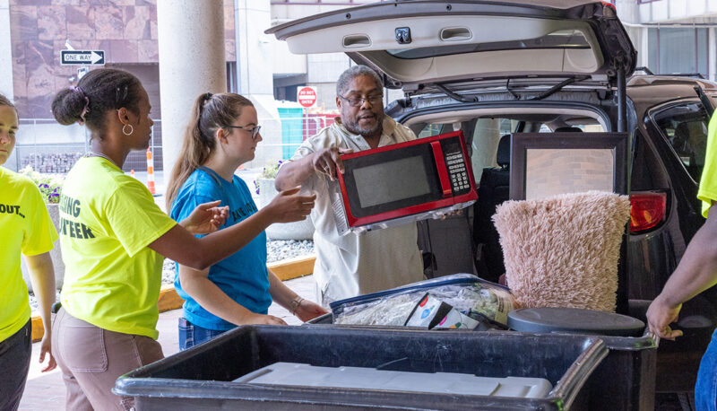 A car being unloaded in front of Riverfront Residence Hall