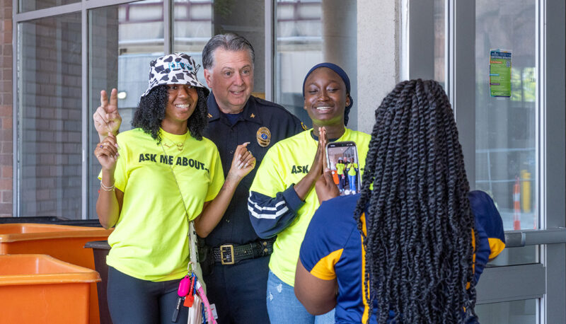 DPS Chief Ray Hall posing for a photo with student volunteers.