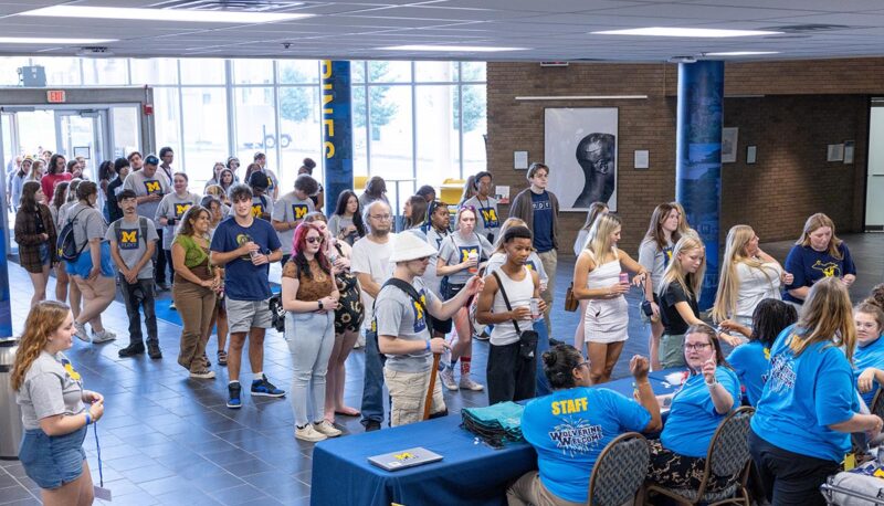 People lining up to check in for Wolverine Welcome