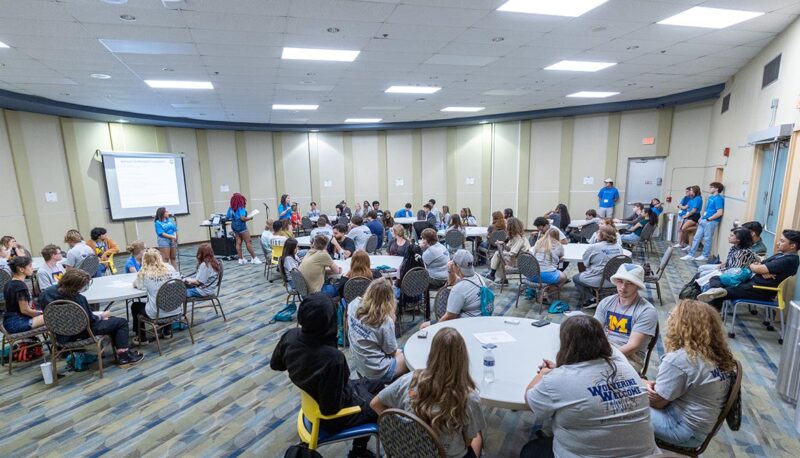 Students seated in the University Center at tables spread throughout the room.