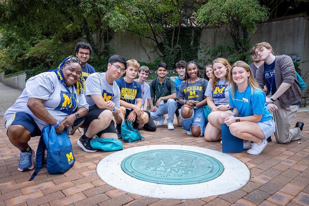 A group of students posing in McKinnon Plaza