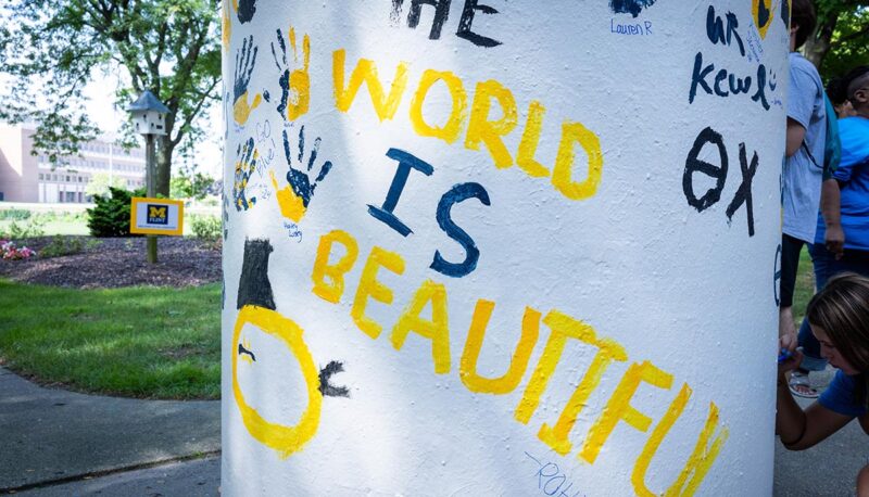 The words "The World is Beautiful" painted on the pillar.