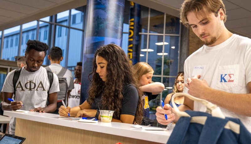 Students filling out name tags.