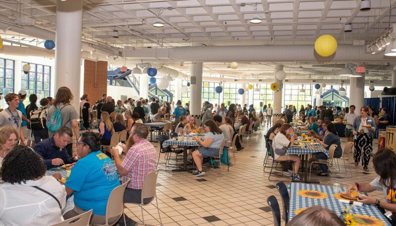 A wide shot of the crowd in the university pavilion during the Chancellor's BBQ