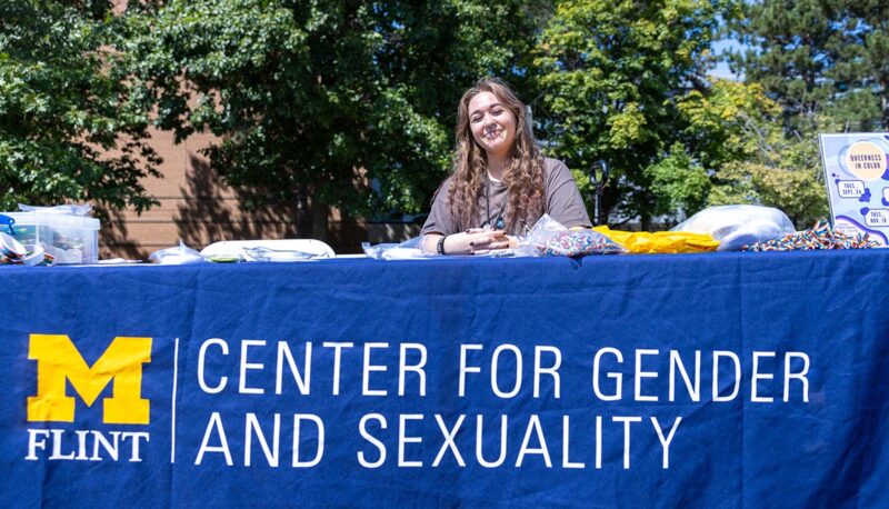 A student sitting at the Center for Gender & Sexuality table.