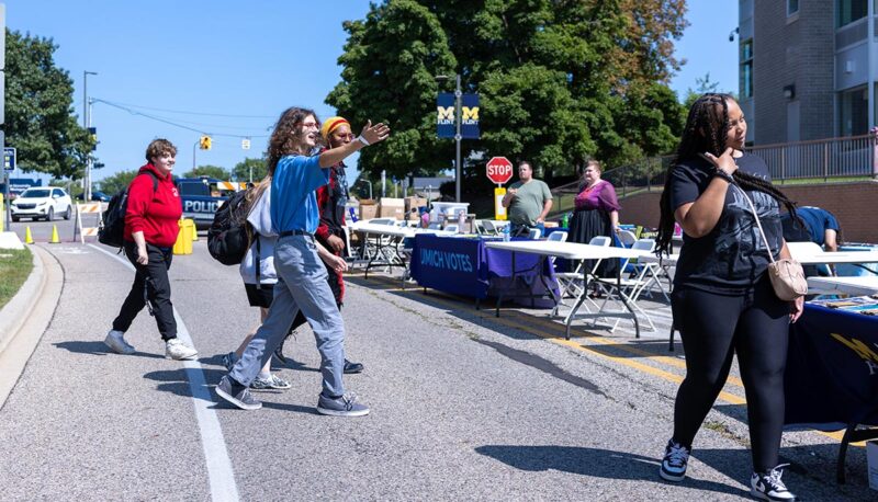 Students walking on Kearsley St. during the MGagement Fair.