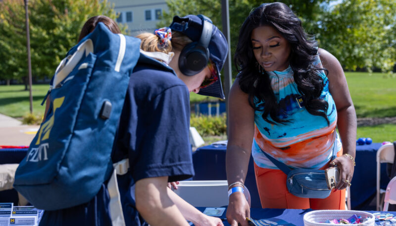 A UM-Flint staff member sharing information with a student.