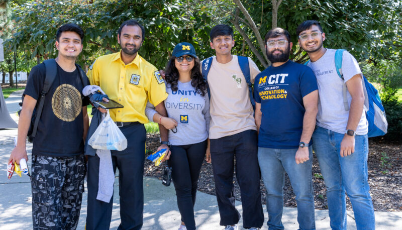 A group of students posing for the camera outside.