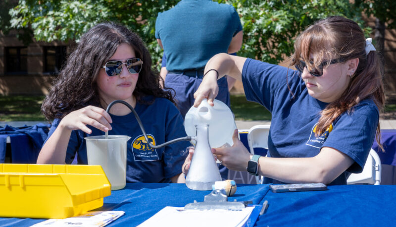 Students who are part of the Chemistry Club conducting an experiment.