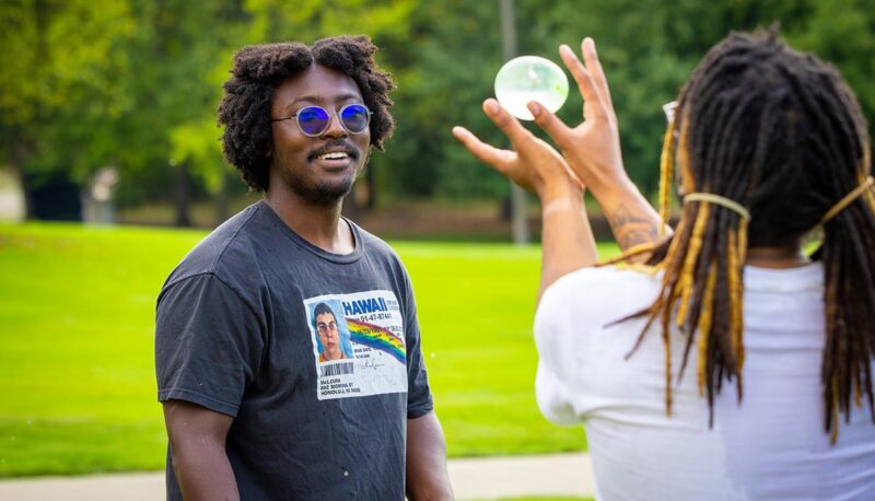 A group of students catching a water balloon