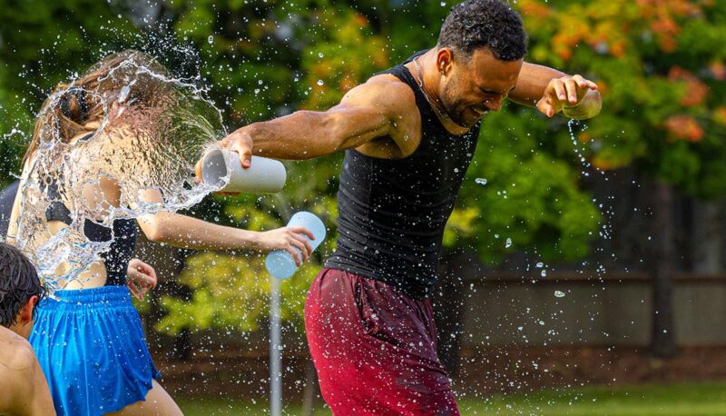 Students splashing water on each other.