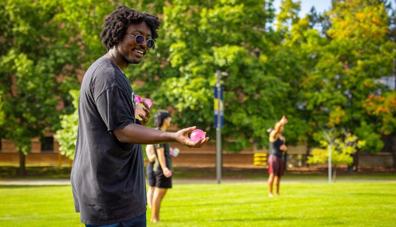 A student preparing to throw a water balloon.